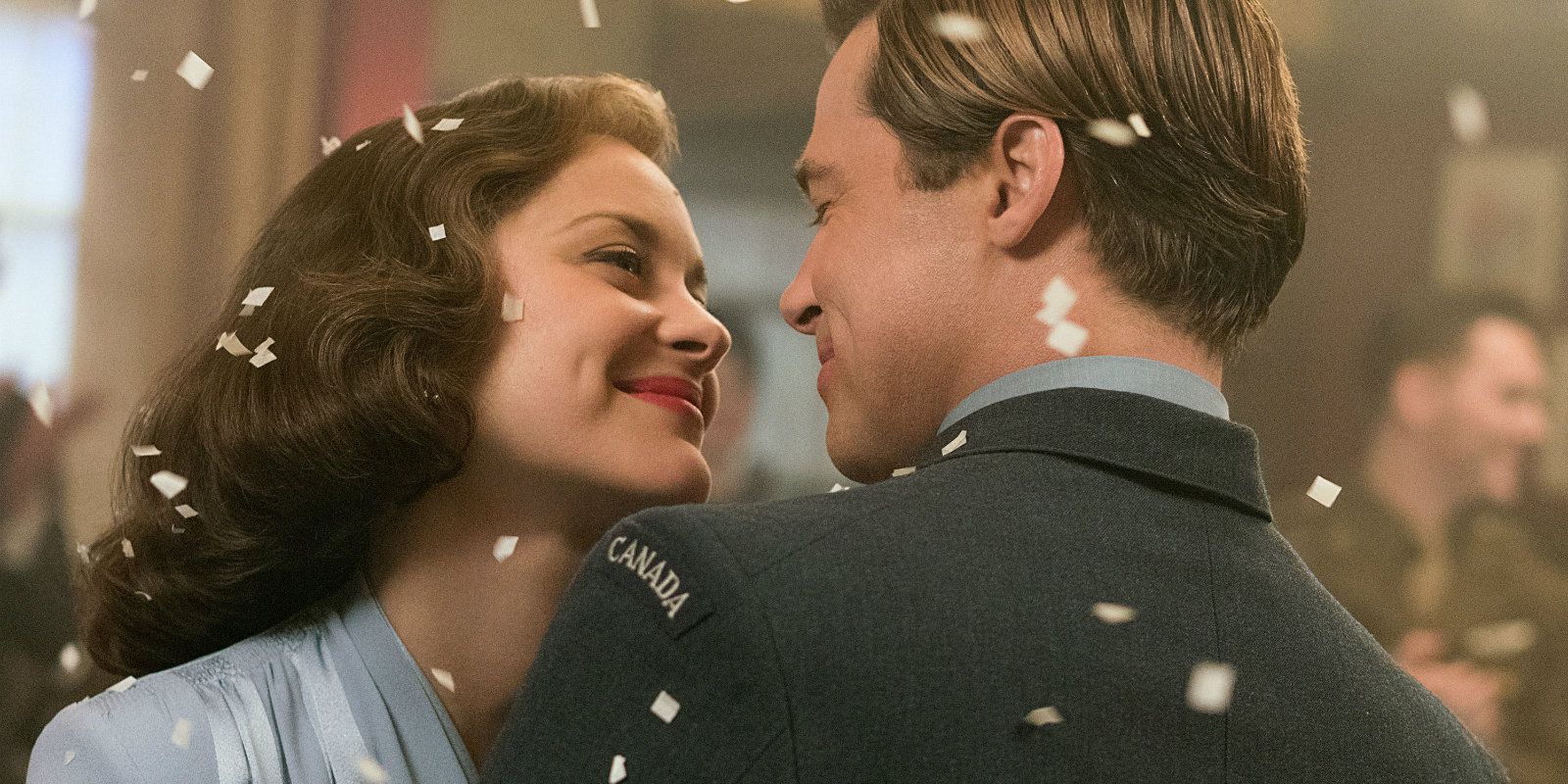 Marion Cotillard and Brad Pitt smile and dance at a party in the film Allied.