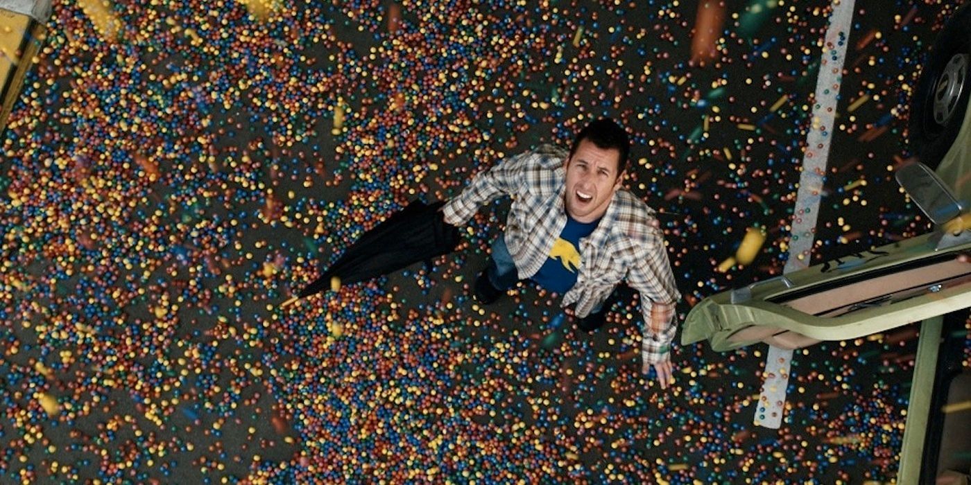 Adam Sandler standing in the gum ball rain in Bedtime Stories