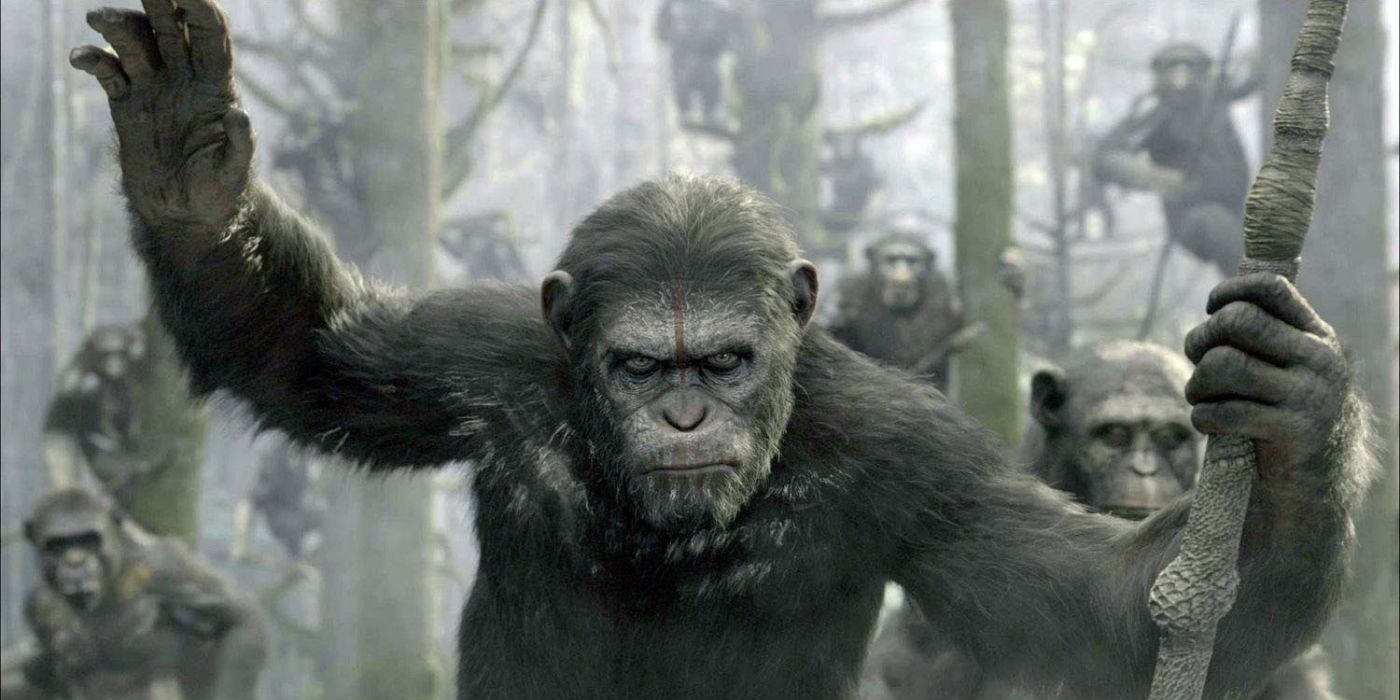 Caesar holds his hand up with apes behind him in Dawn of the Planet of the Apes