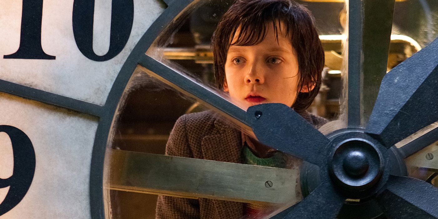Asa Butterfield in Hugo looking through a giant clock