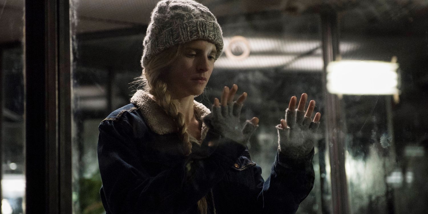 Prairie touches the glass with her hands in The OA Season 1
