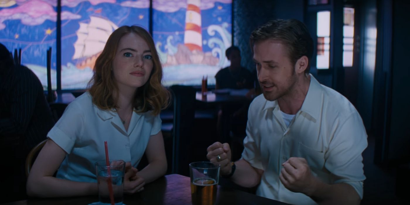 Emma Stone as Mia and Ryan Gosling as Sebatian sitting in a club in La La Land