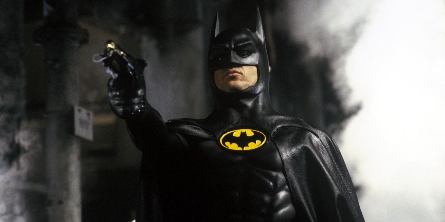 Michael Keaton as Batman holding a grappling gun in Batman 1989