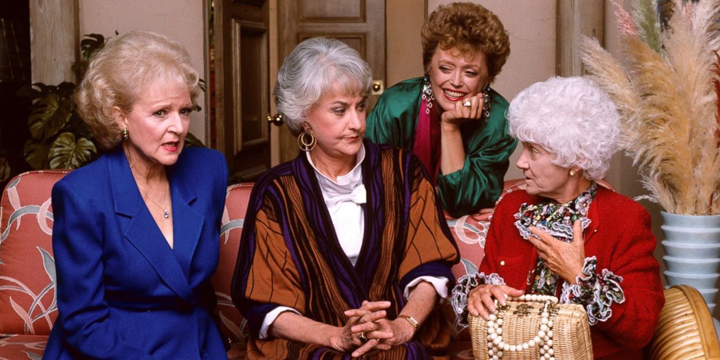 The Golden Girls cast sat chatting on a couch in Golden Girls