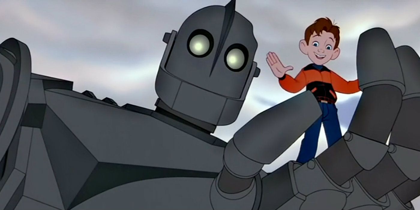 A little boy waves while being held by a giant robot from The Iron Giant