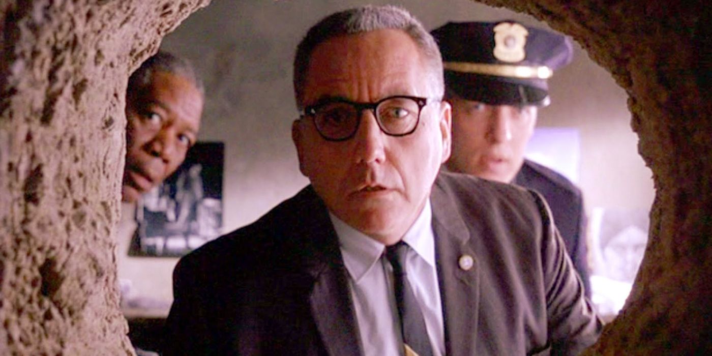 Diretor Norton olhando pelo buraco na parede de Andy em The Shawshank Redemption