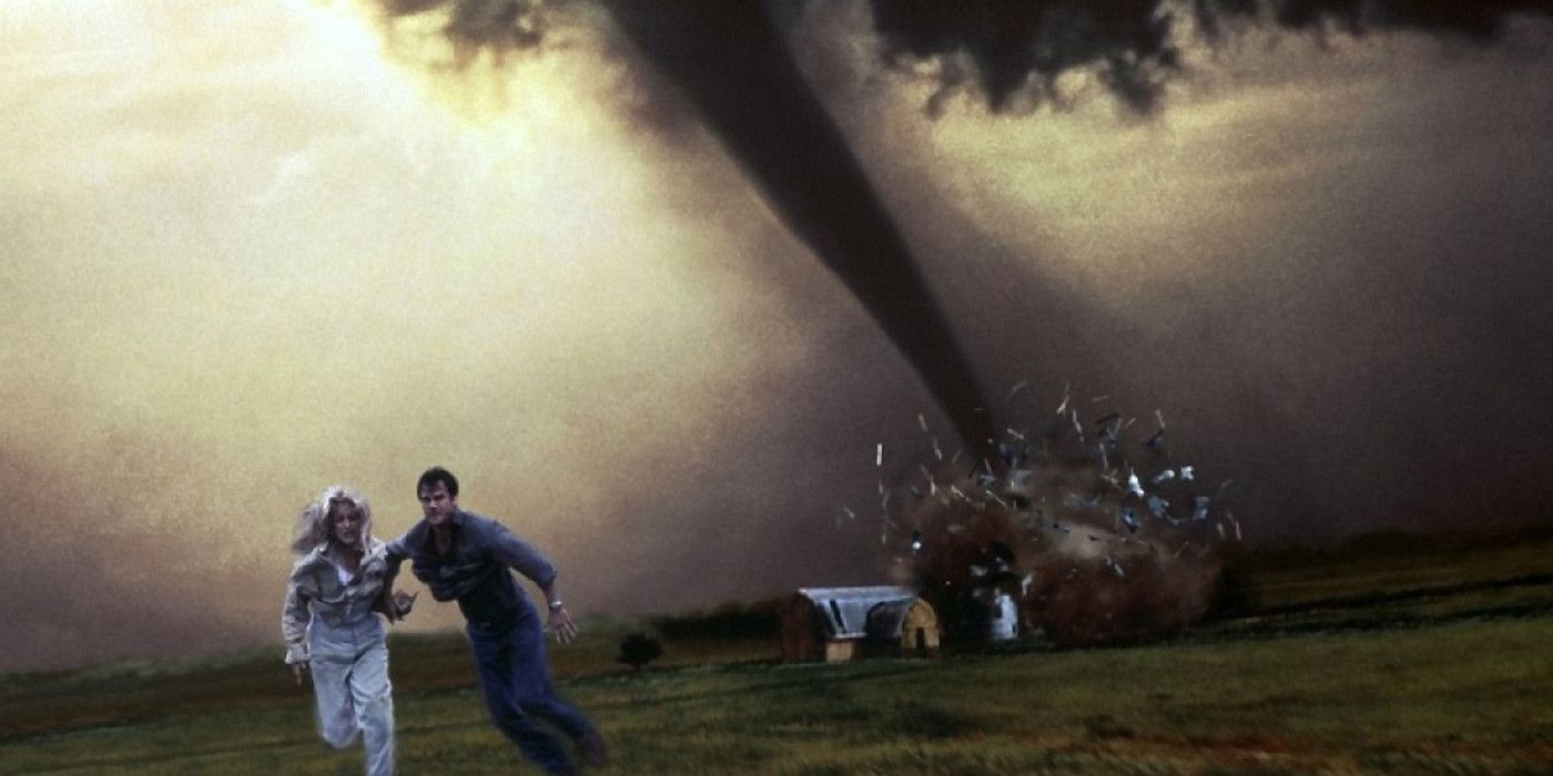 Helen Hunt and Bill Paxton running from a tornado on the poster for Twister.