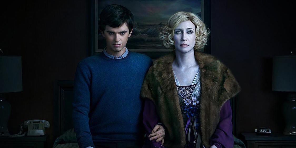 Norman Bates holding Norma Bates' corpse and smiling in Bates Motel 
