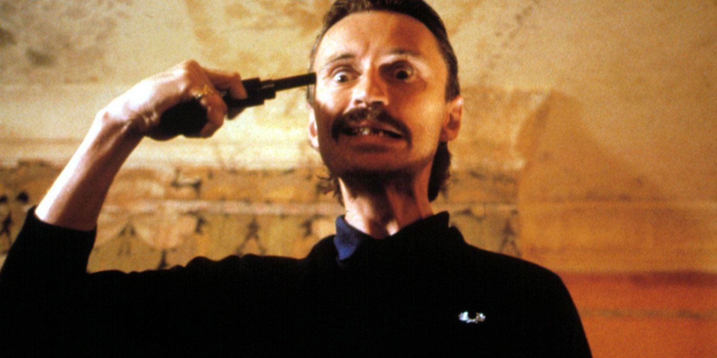 Begbie points a gun at his temple in T2 Trainspotting