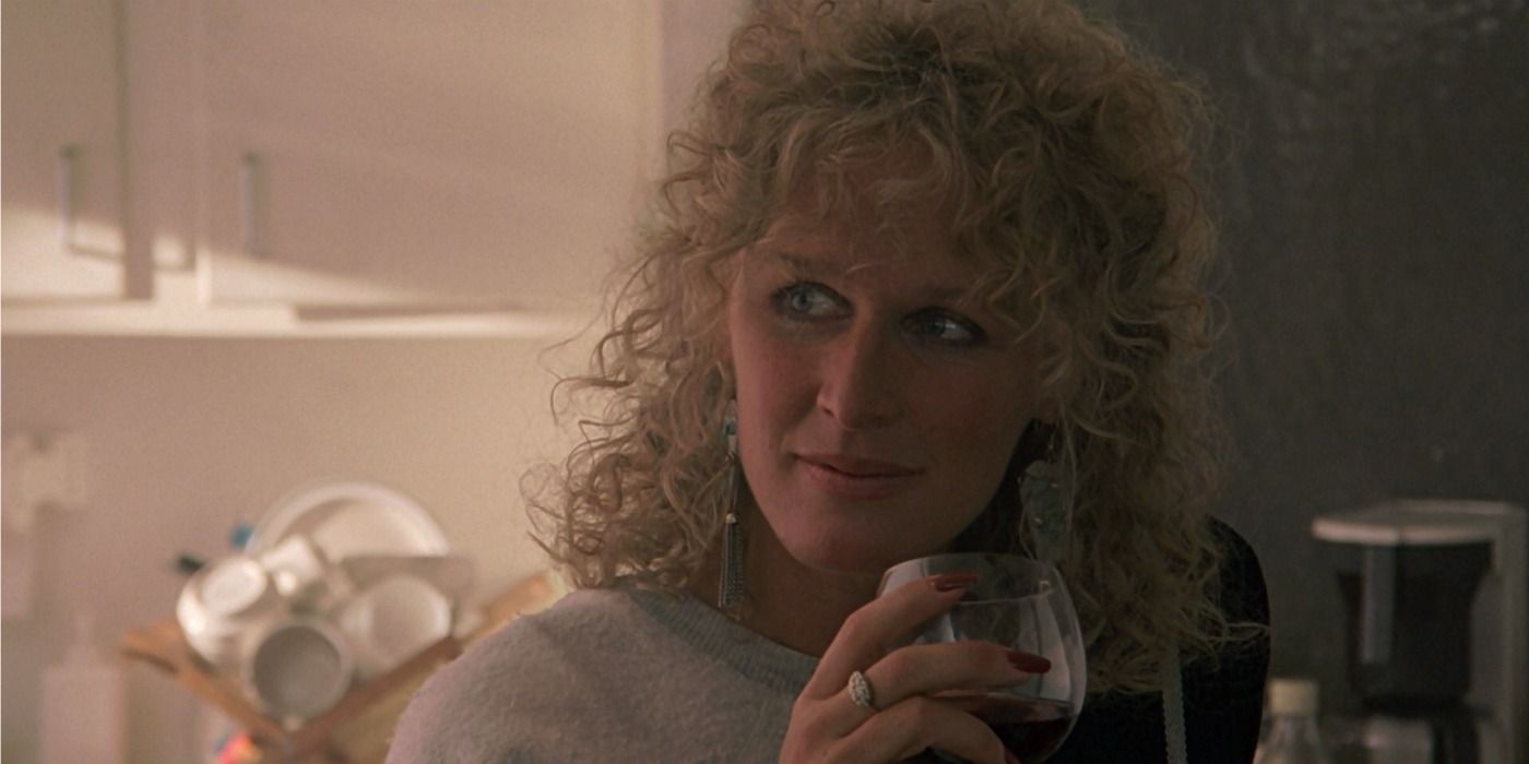 Glenn Close as Alex in Fatal Attraction holding a glass of wine and looking to the left