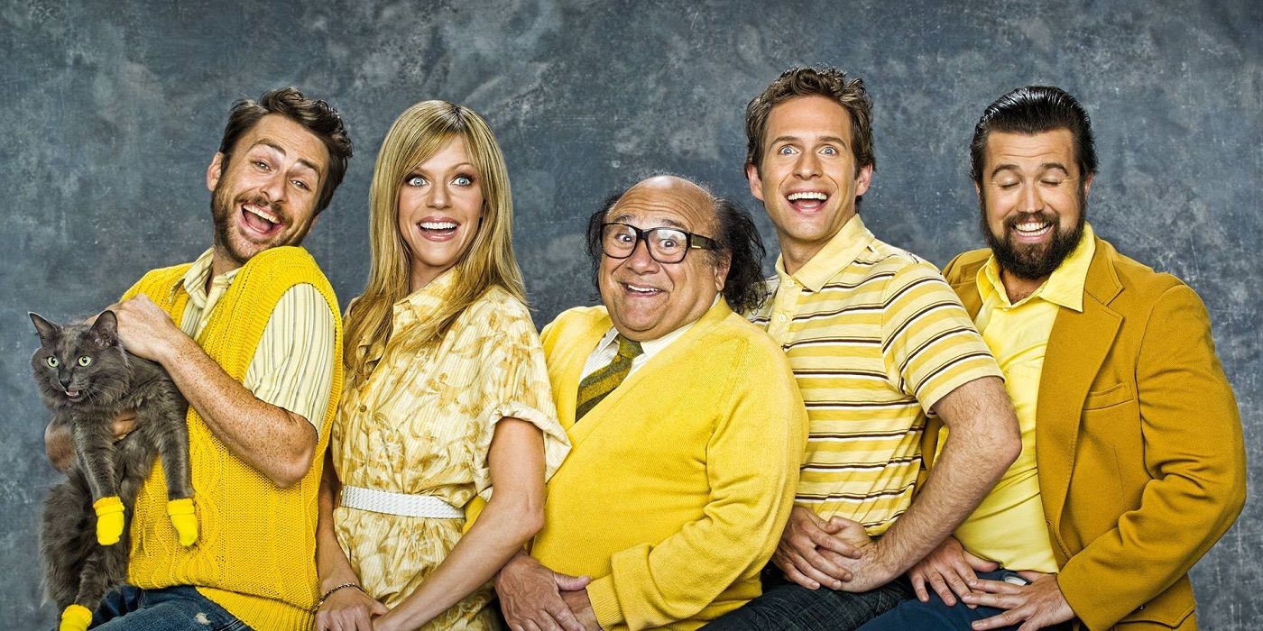 The cast of It's Always Sunny wearing yellow outfits and smiling