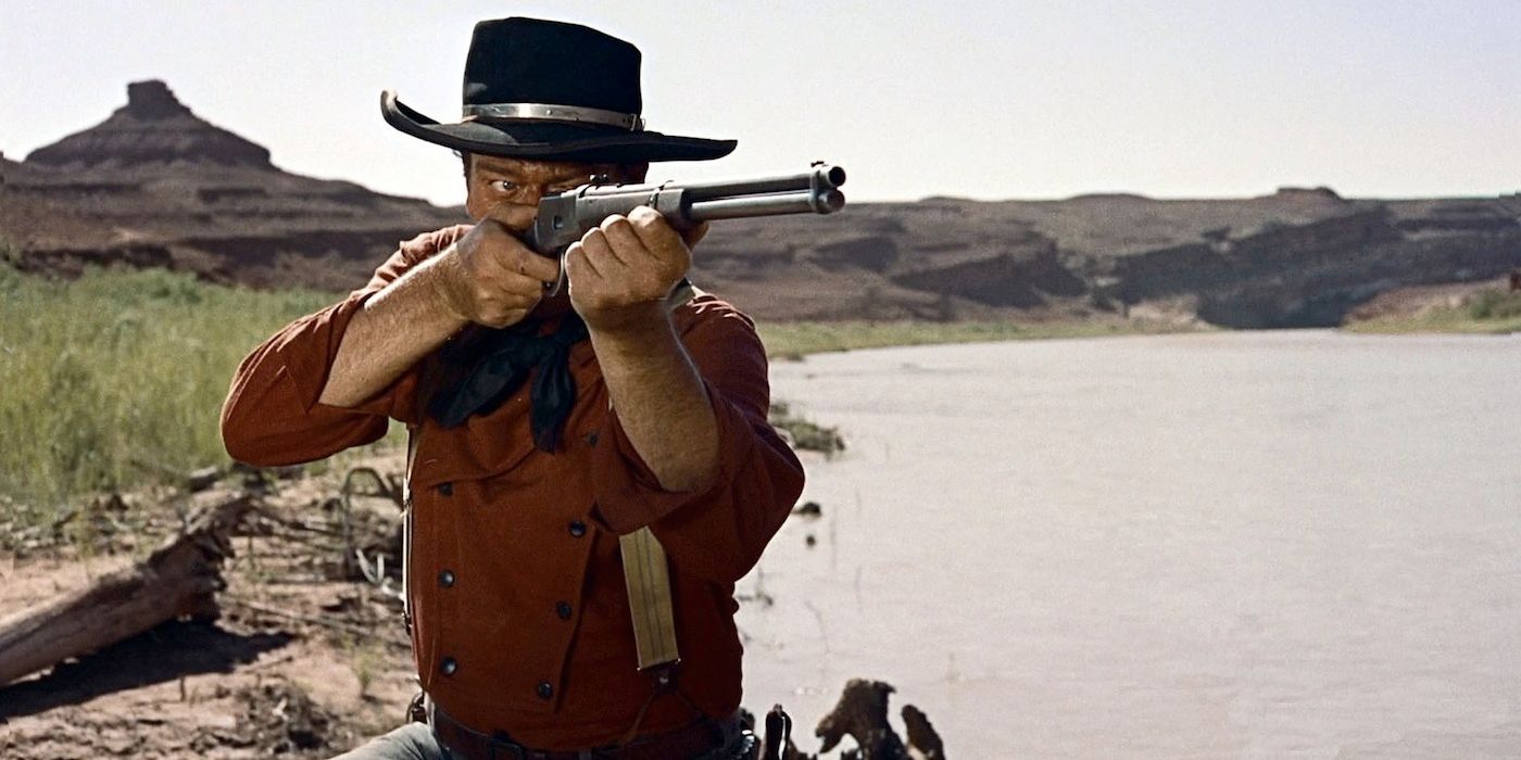 John Wayne holding a rifle in The Searchers