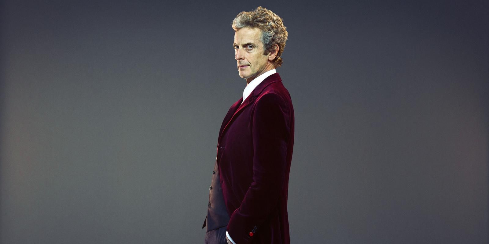 The Twelfth Doctor standing against a grey background