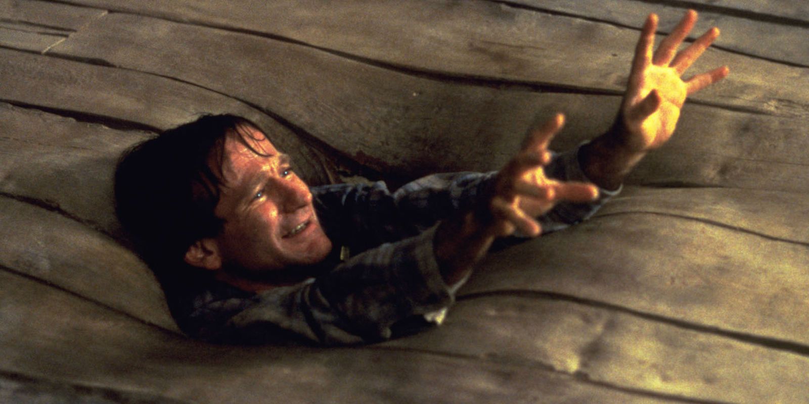 Robin Williams sinking into the floor in Jumanji