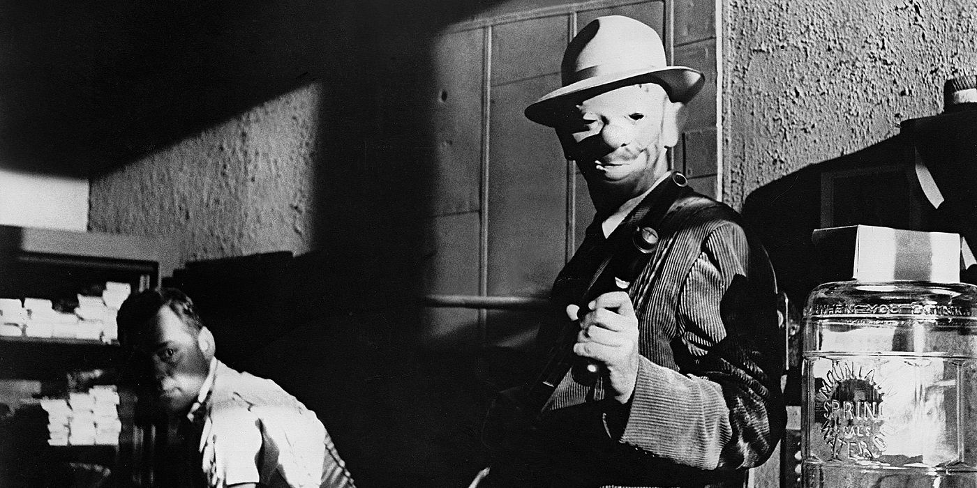 A man in a mask holding a man hostage in The Killing