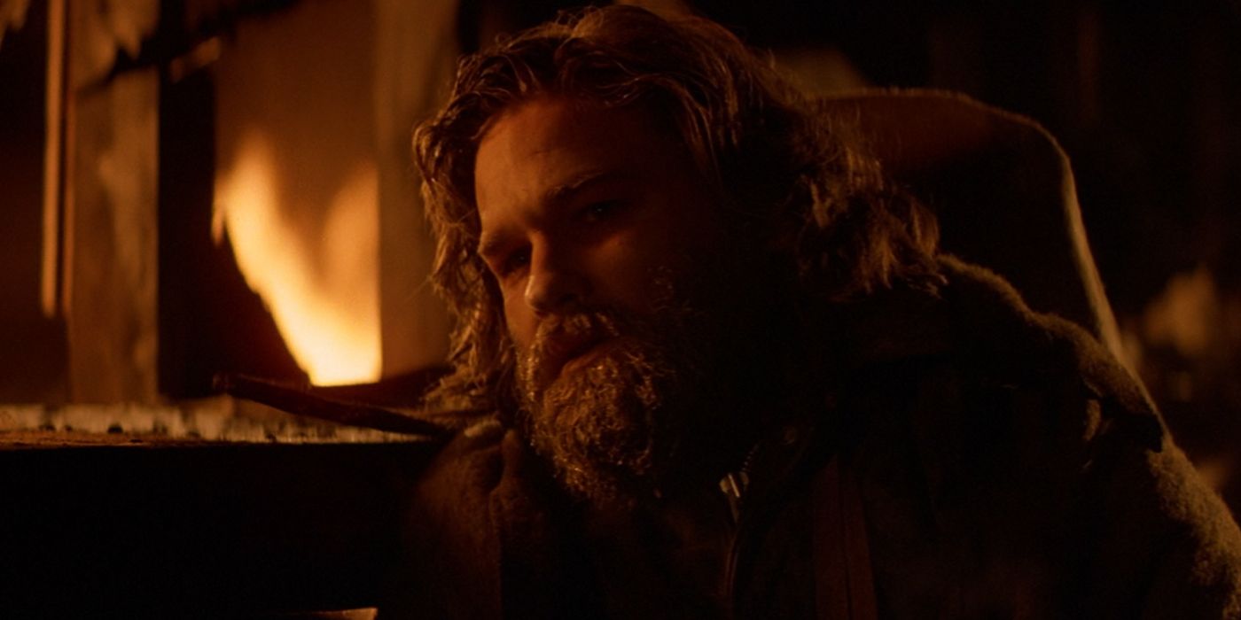 Kurt Russell as MacReady in close up with a fire in the background in The Thing
