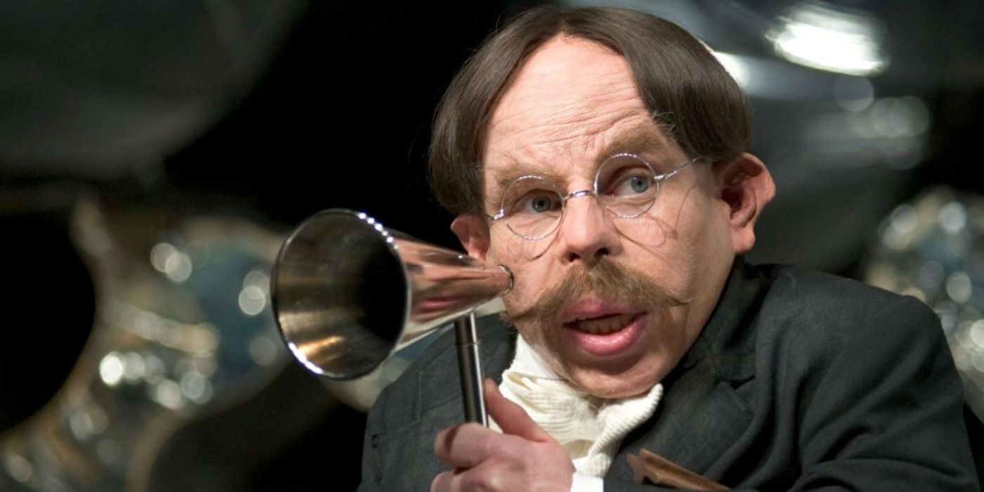 Filius Flitwick holding a magical megaphone in Harry Potter