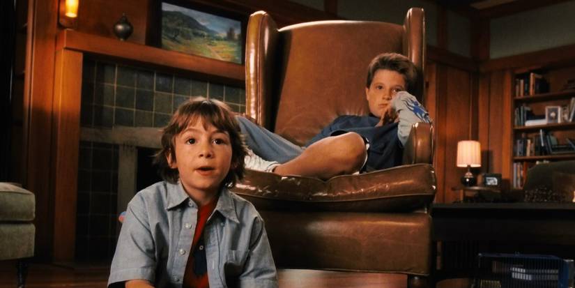 The two brothers sit in their living room in Zathura: A Space Adventure