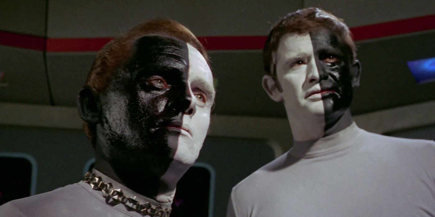 Two Cheron stand side by side while looking on from The Original Series