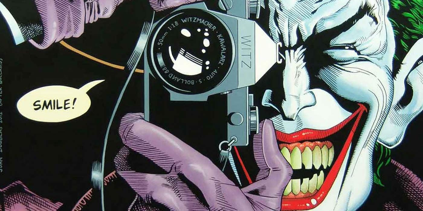 Joker smiling and holding a camera in The Killing Joke