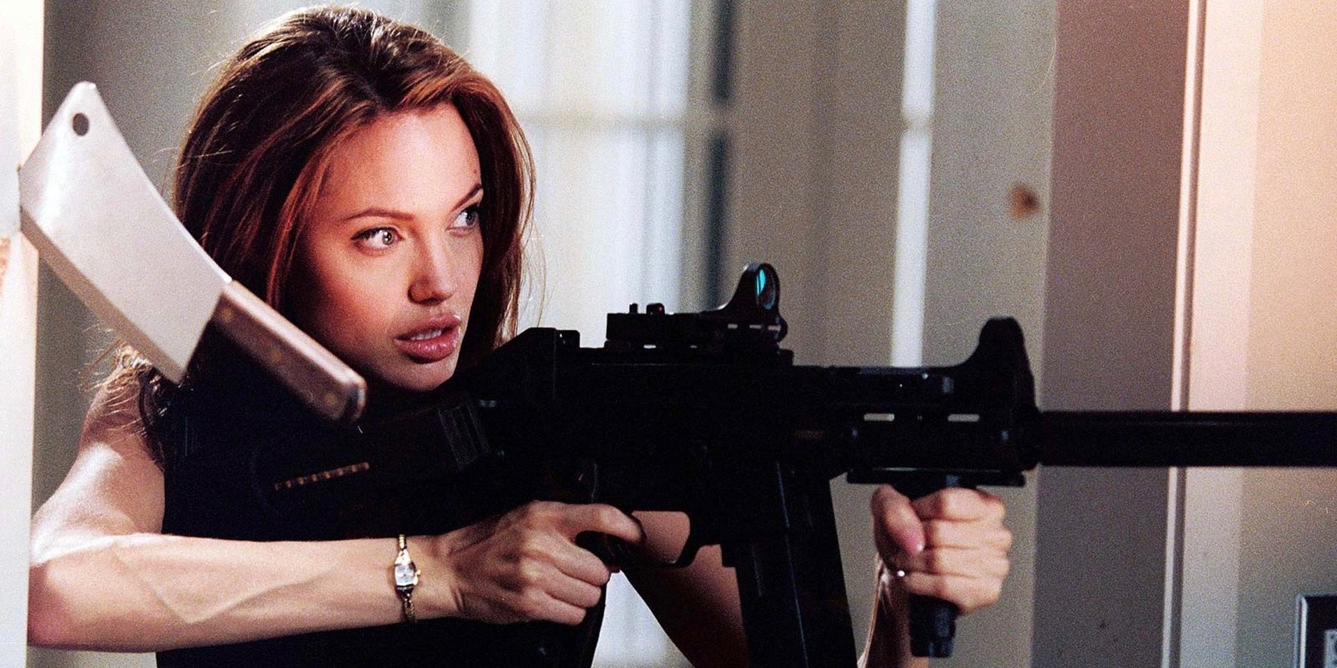 Angelina Jolie with a machine gun in Mr. & Mrs. Smith with a meat cleaver by her head