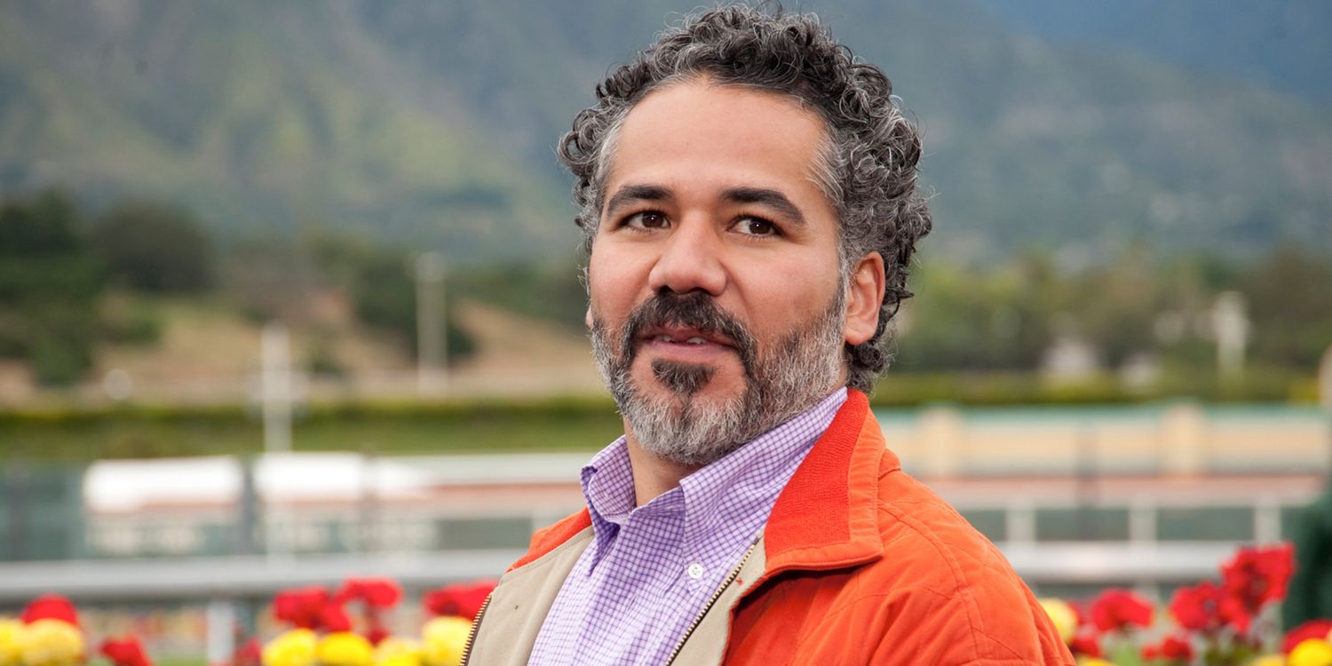 John Ortiz wears an orange jacket in HBO's Luck