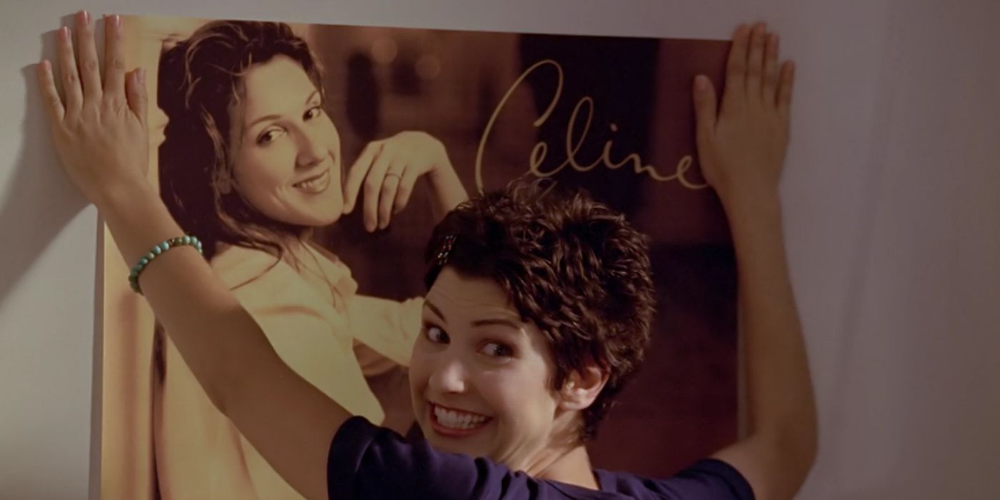 Kathy Newman smiling while hanging a Celine Dion poster in Buffy the Vampire Slayer