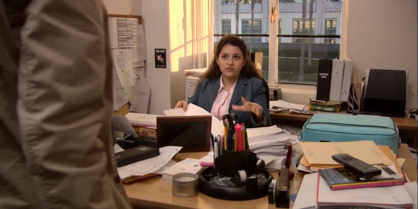 This image shows Maeby at a messy desk in a film production company in Arrested Development.