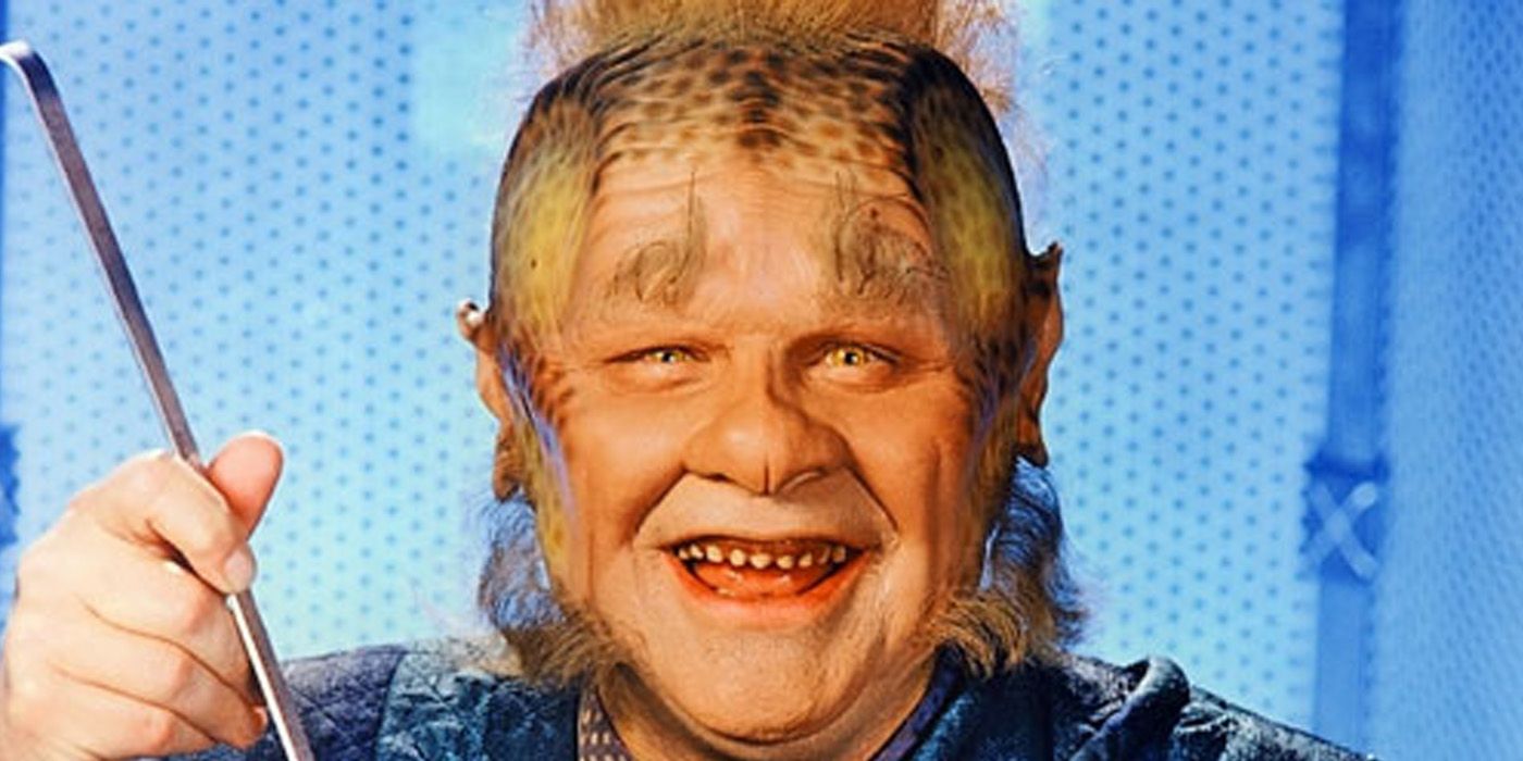 Neelix smiles while holding a spoon from Star Trek Voyager