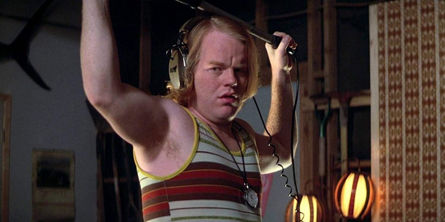 Philip Seymour Hoffman in Boogie Nights holding a boom mic.