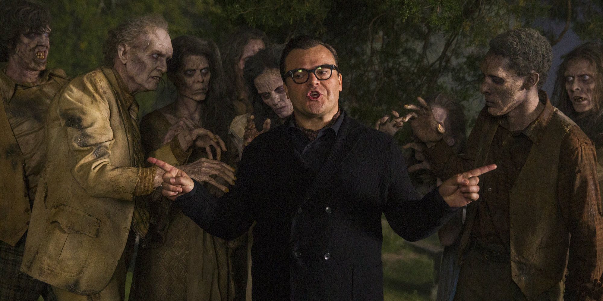 Jack Black as R.L. Stine surrounded by zombies in Goosebumps - 