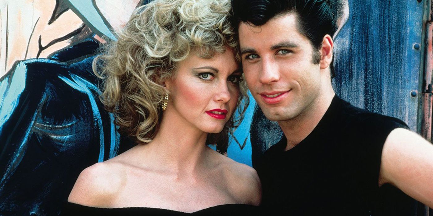 Olivia Newton-John and John Travolta standing together in Grease