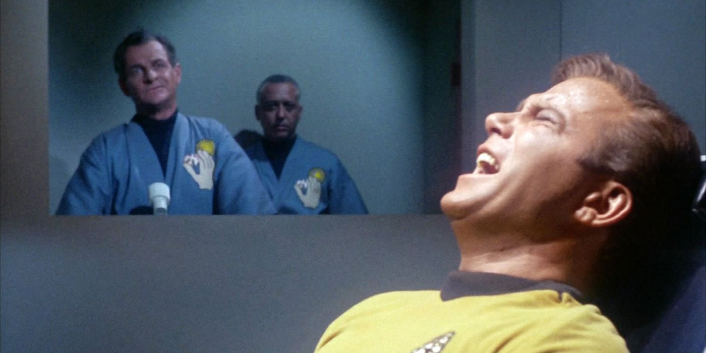 Kirk's mind is tortured while two men look on from Dagger of the Mind