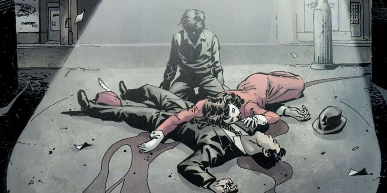 Bruce kneeling beside his parents' corpses in DC Comics