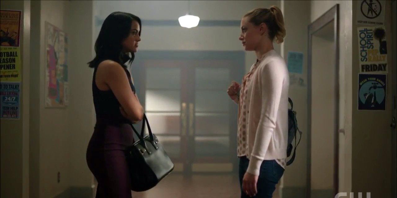 Betty and Veronica face each other in the hallway in Riverdale.