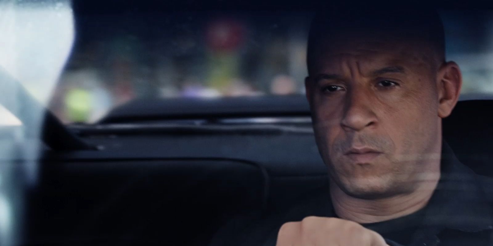 Dominic Toretto looking serious behind the wheel of a car in Fate of the Furious.