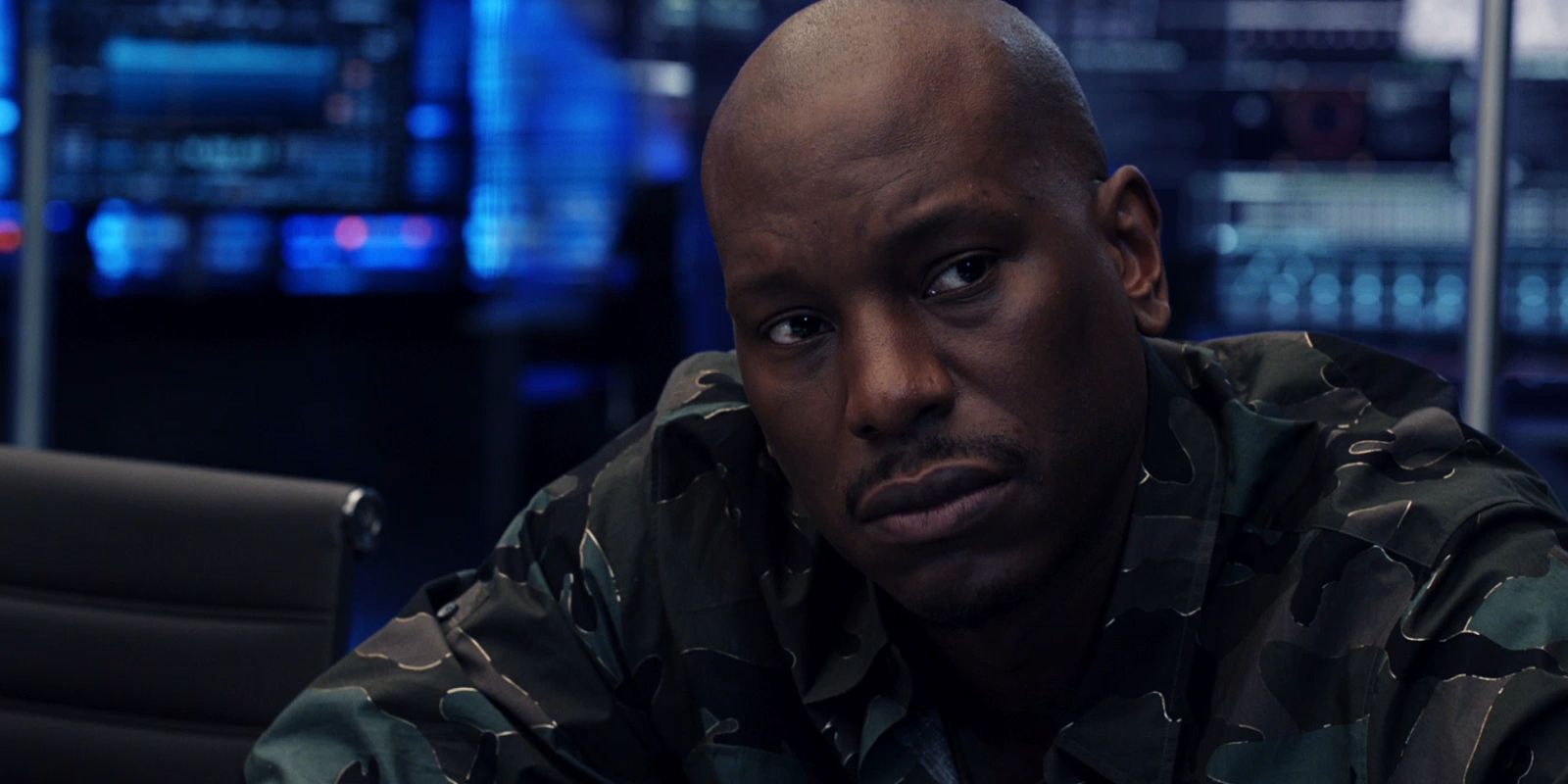 Tyrese Gibson as Roman Pearce looking sideways in Fate of the Furious