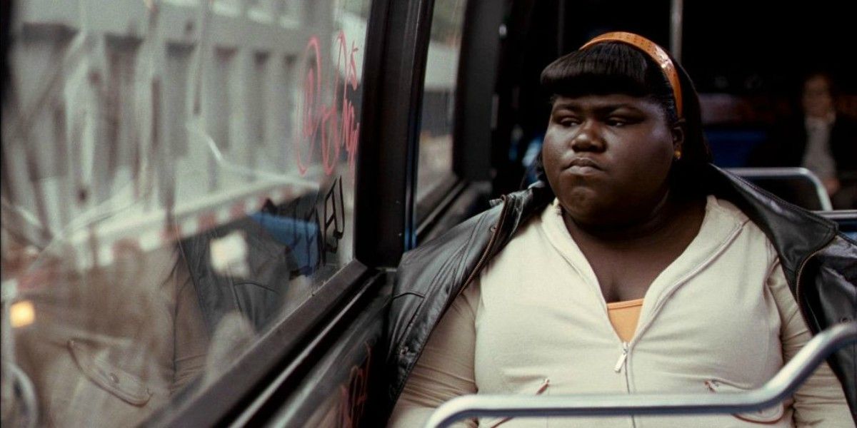 Precious rides a bus and looks out the window in Precious