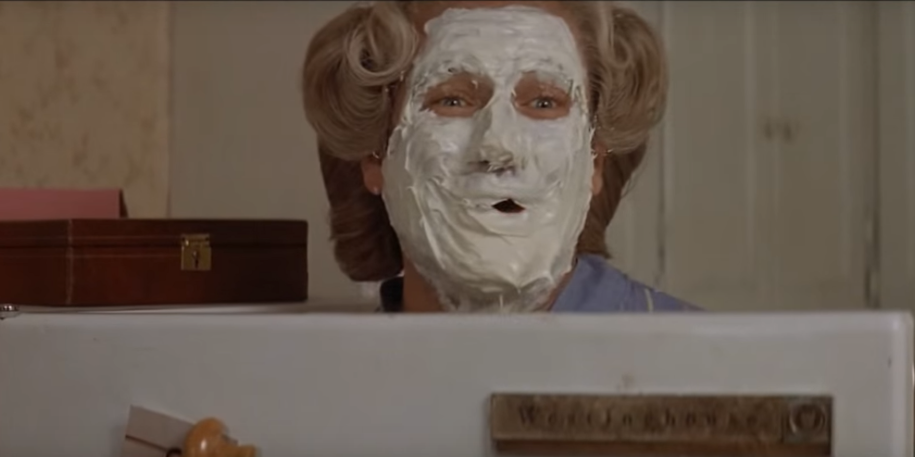 Robin Williams as Mrs Doubtfire with whipped cream on face