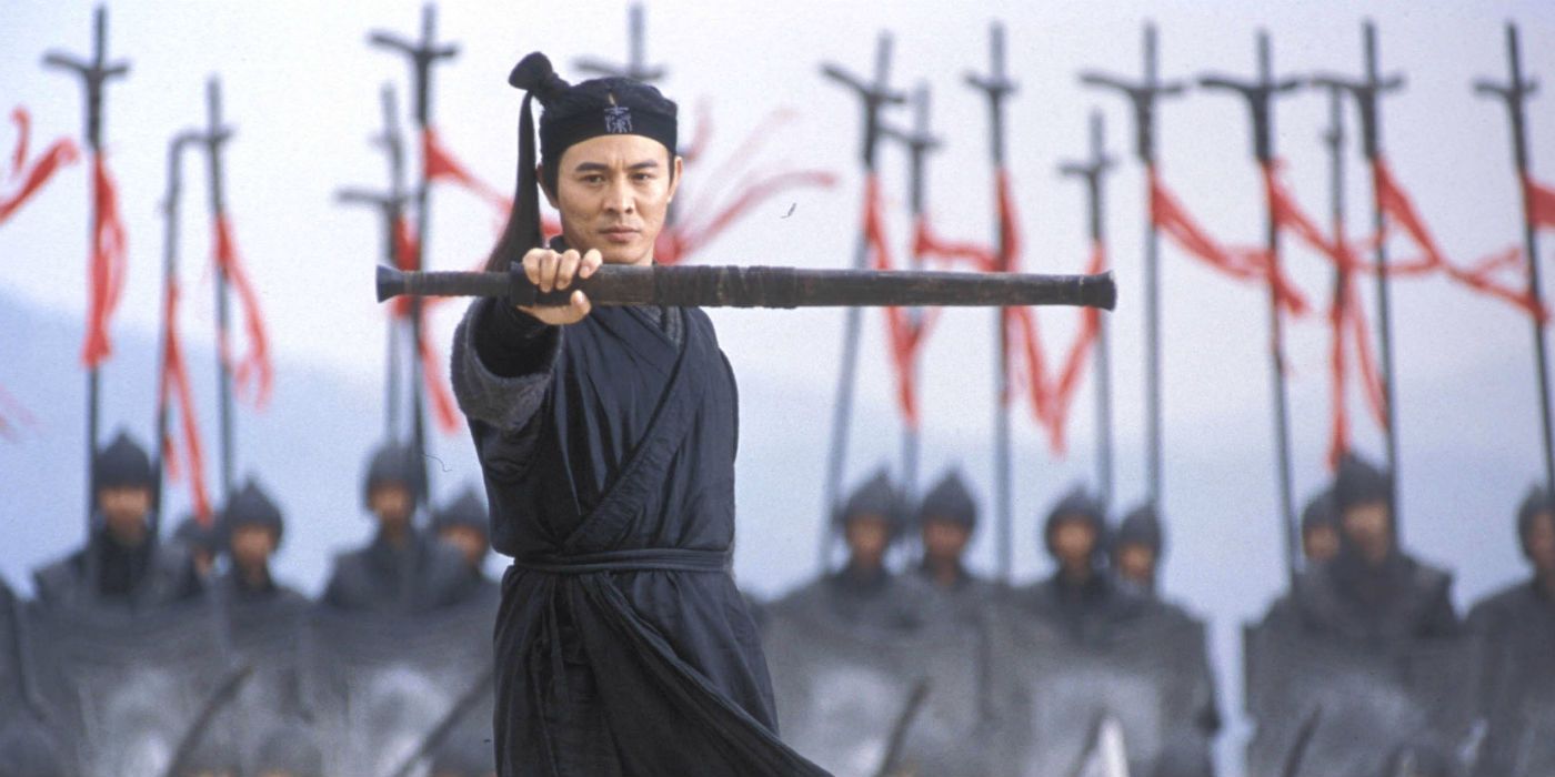 Jet Li with hold up his sheathed sword in the film Hero.