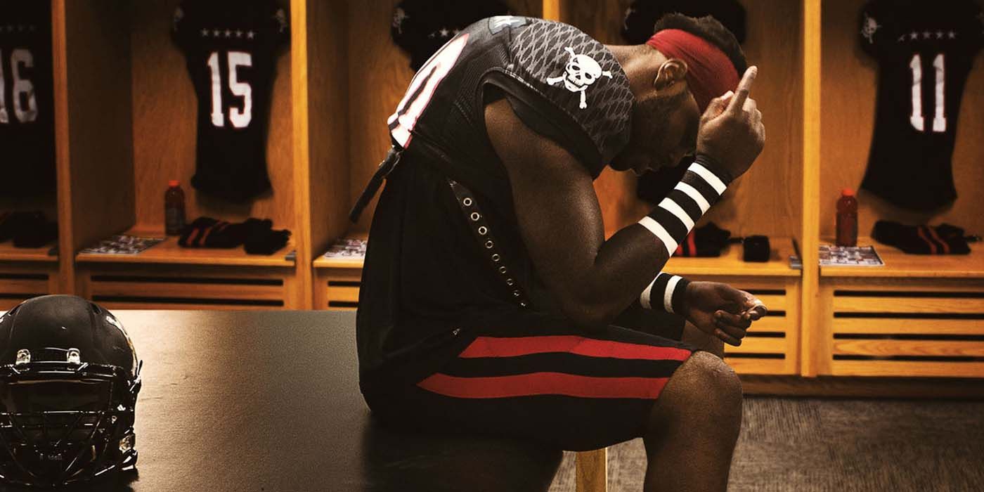 A player relaxes in a locker room in Last Chance U