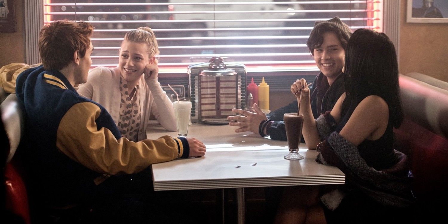 Archie, Betty, Jughead, and Veronica sitting in a booth at Pop's