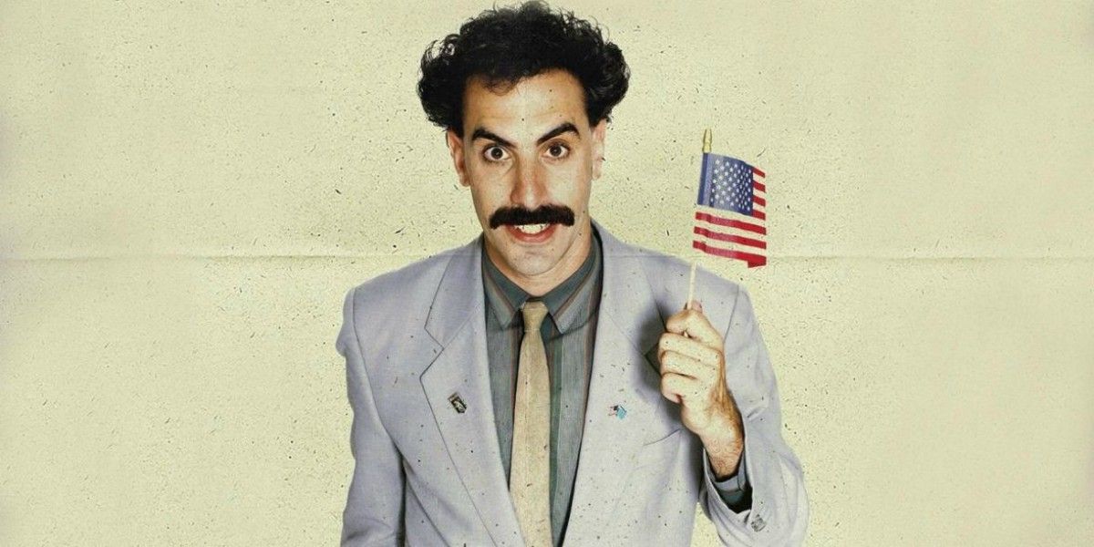 Borat holding a tiny American flag