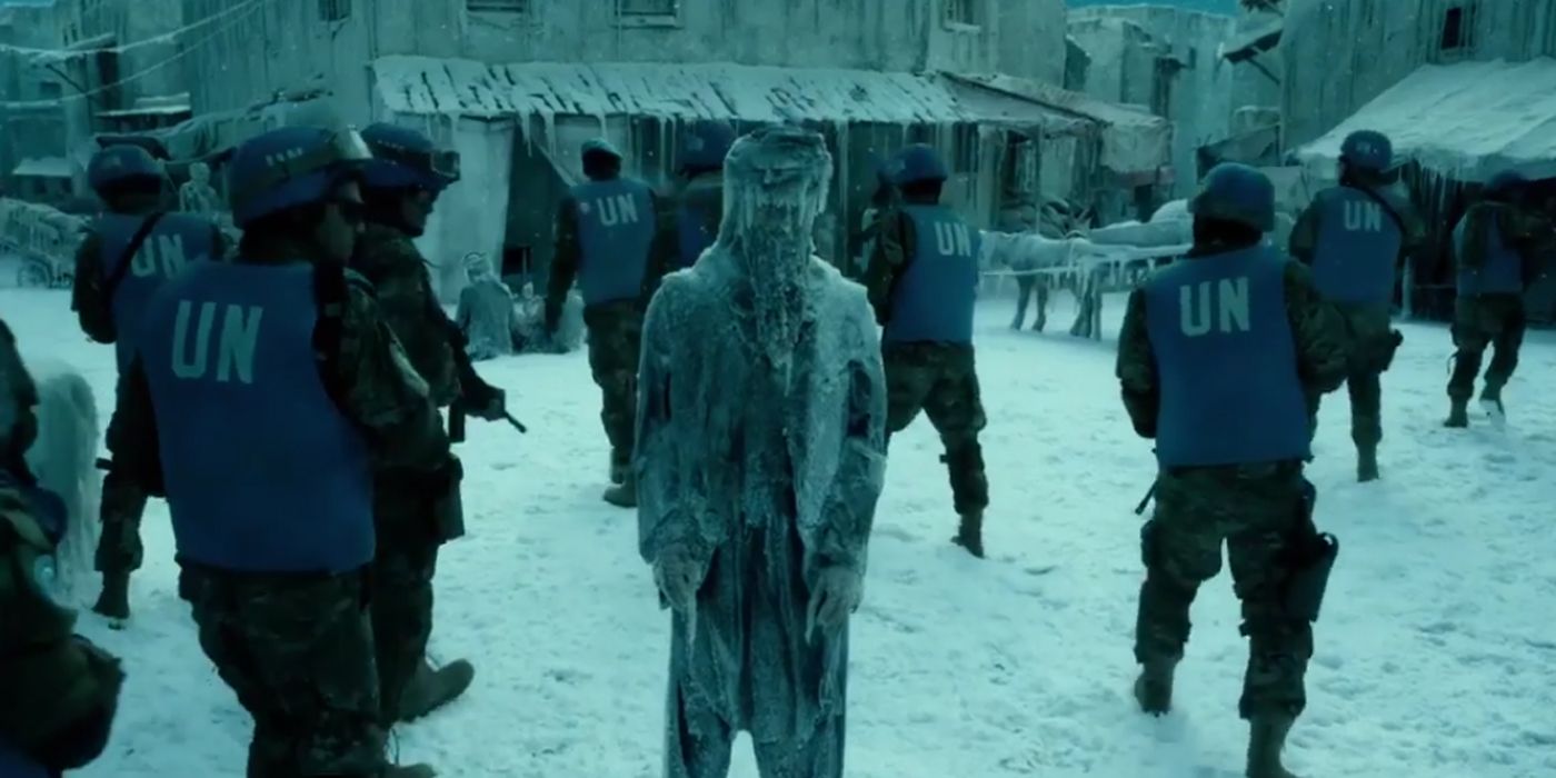 A still from the Geostorm trailer: a group of soldiers surround a frozen man.