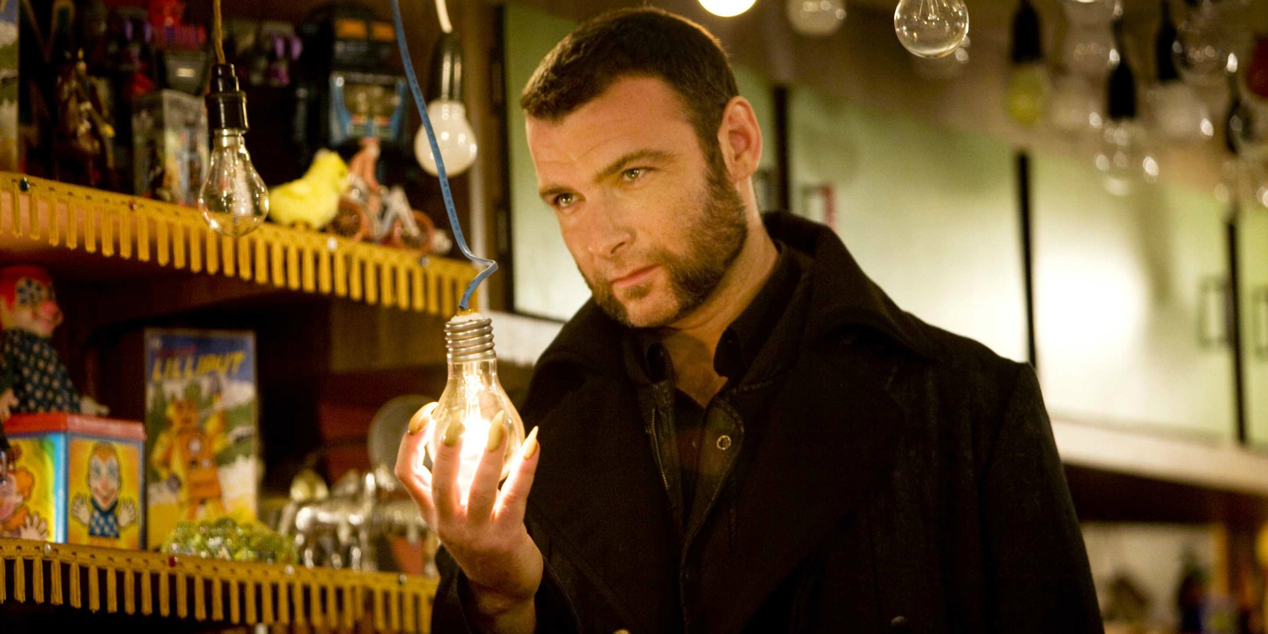 Liev Schreiber's Sabertooth holds a lightbulb