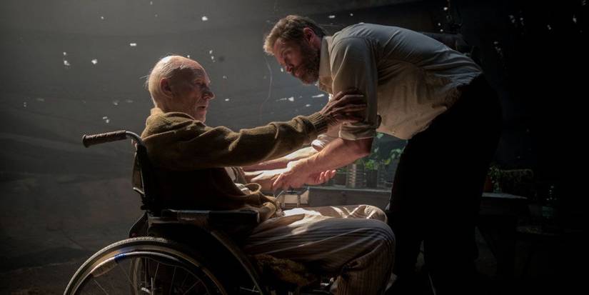Patrick Stewart as Charles Xavier holding the arm of Hugh Jackman as Wolverine in Logan, 2017
