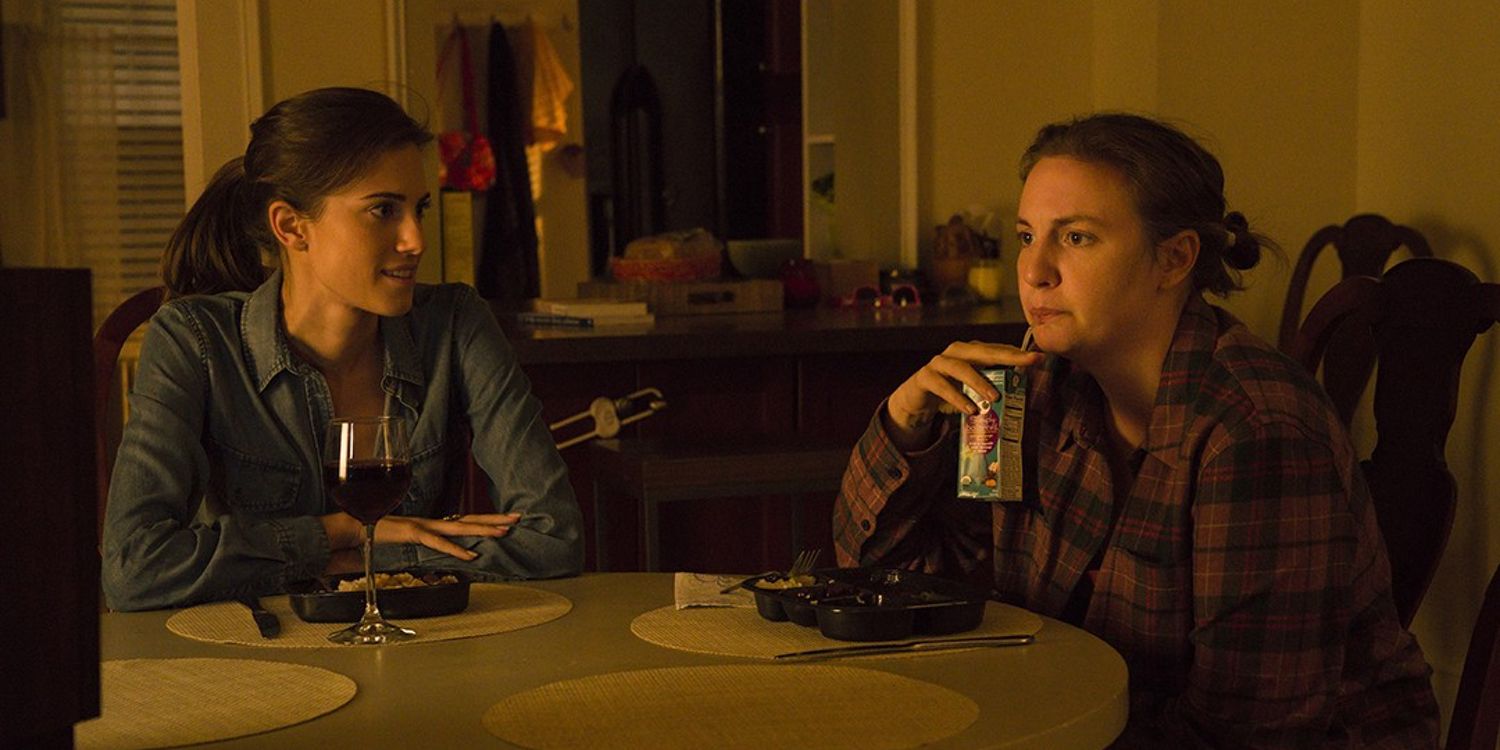 Allison Williams and Lena Dunham sitting on a table in Girls