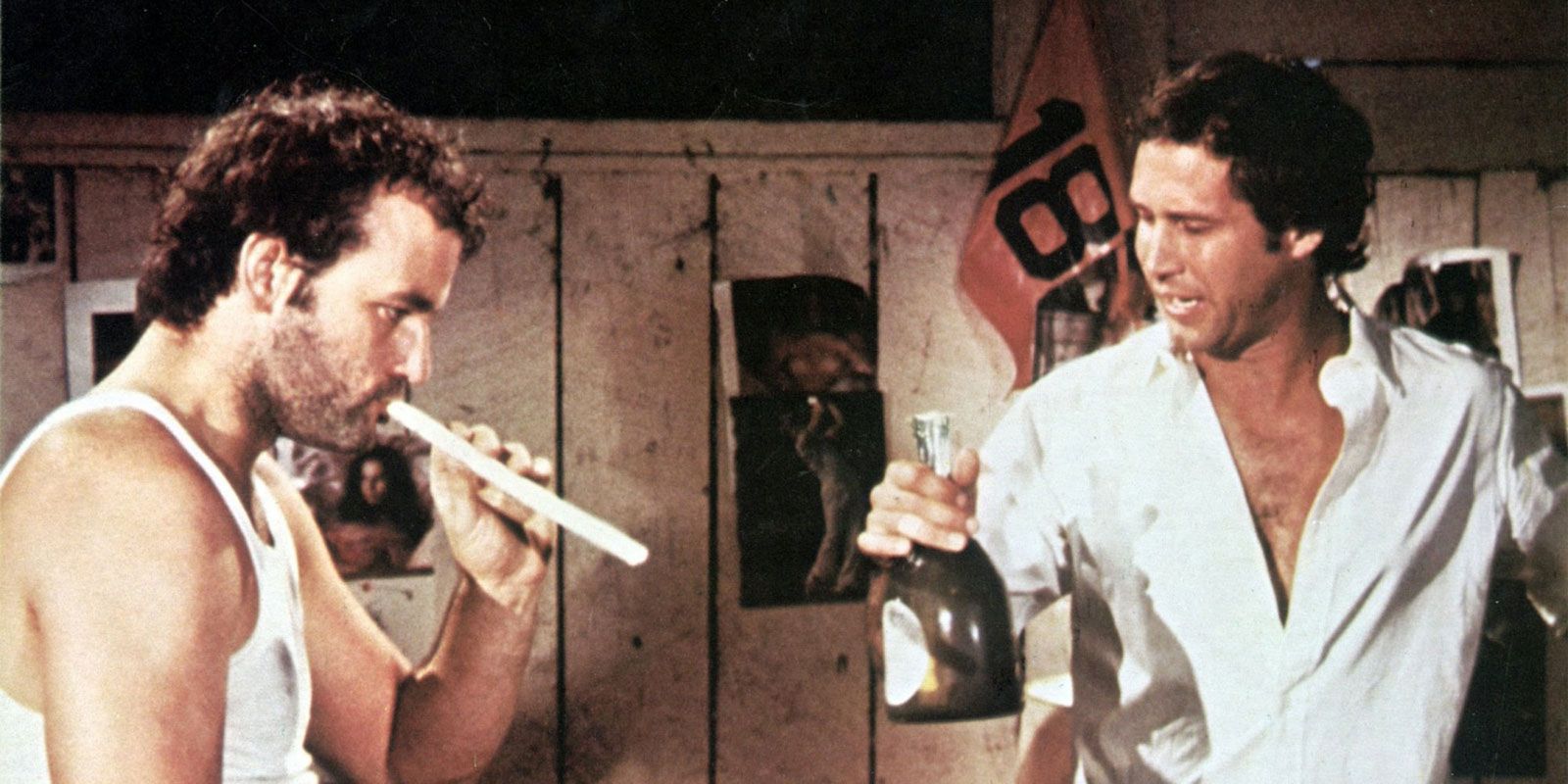 Bill Murray and Chevy Chase holding an alcohol bottle in Caddyshack