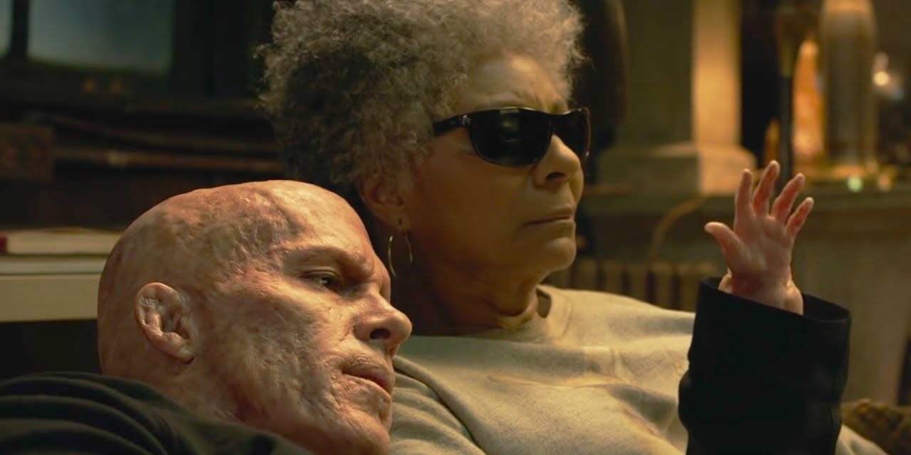 Wade with his tiny hand next to Blind Al in Deadpool