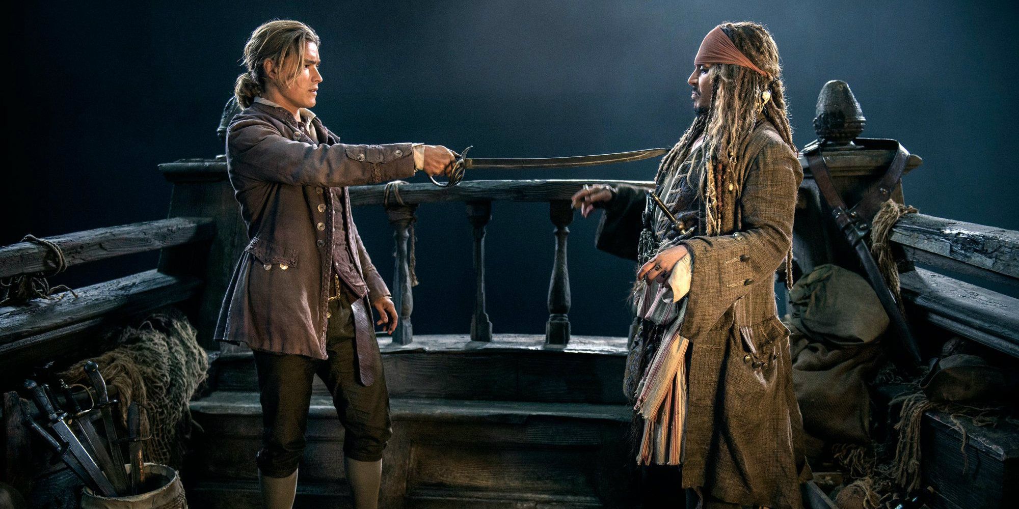 Brenton Thwaites as Henry Turner pointing a sword at Johnny Depp as Jack Sparrow in Pirates of the Caribbean: Dead Men Tell No Tales